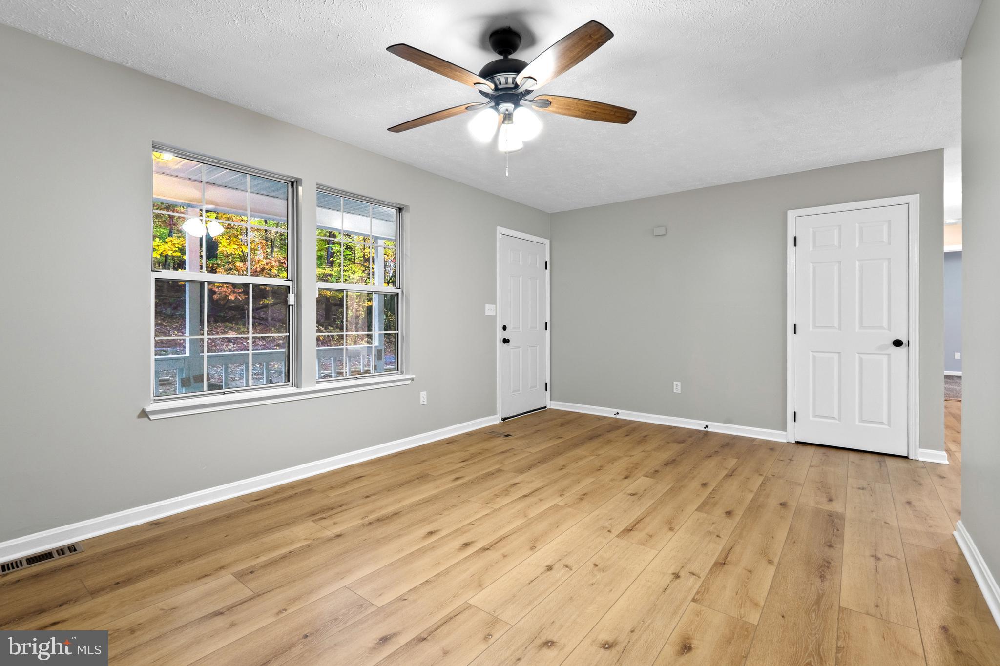 369 Wild Hare Road Harpers Ferry, WV 25425 - Photo 10 of 29 a view of an empty room with a window and wooden floor
