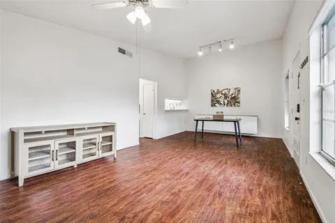 a living room with furniture and a wooden floor