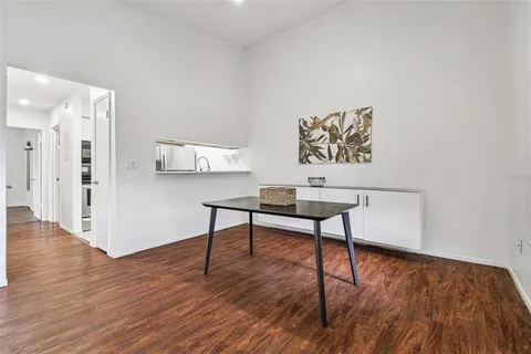 a view of a workspace with furniture and wooden floor
