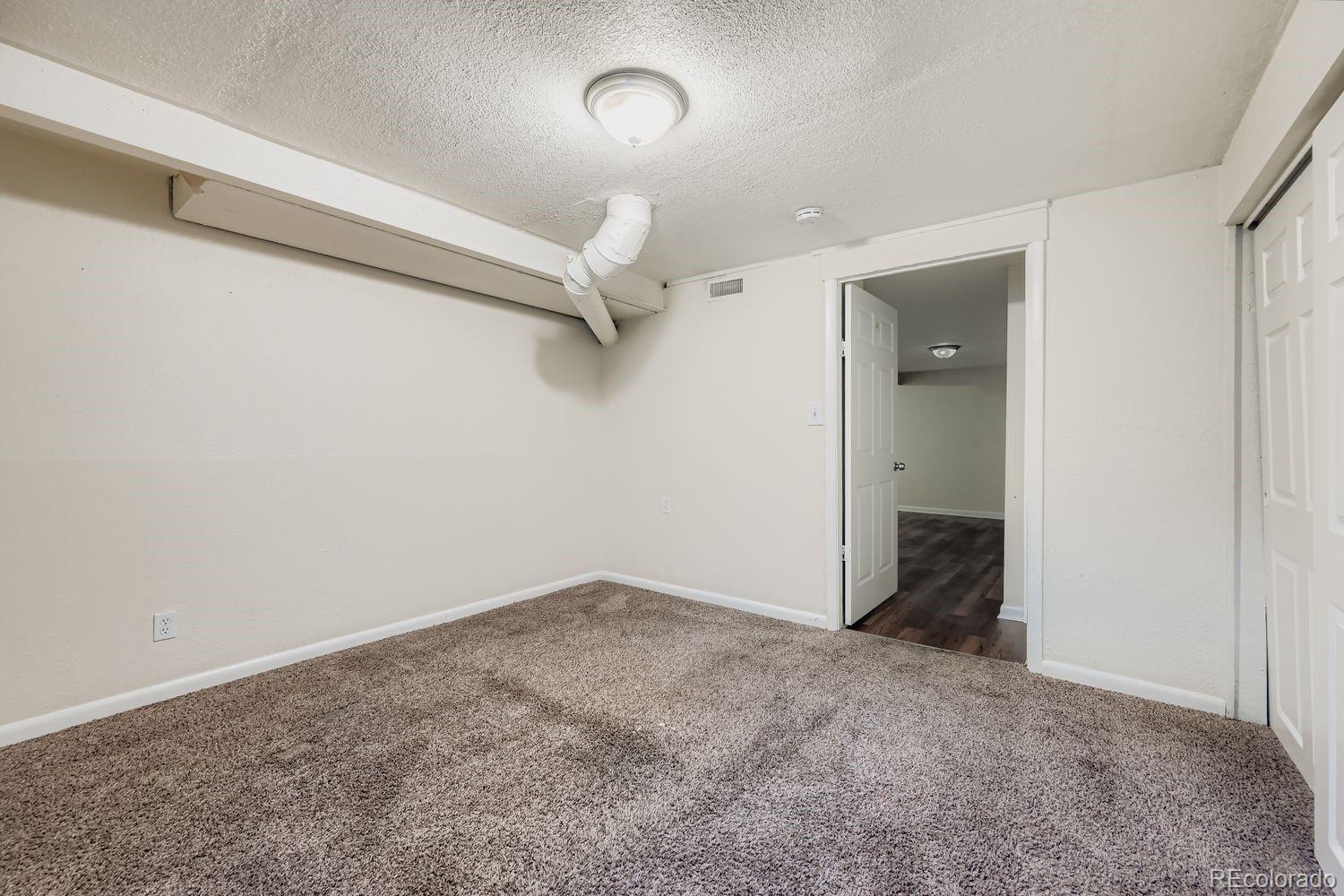 3690 Magnolia Street Denver, CO 80207 - Photo 11 of 17 an empty room with a empty space and a ceiling fan