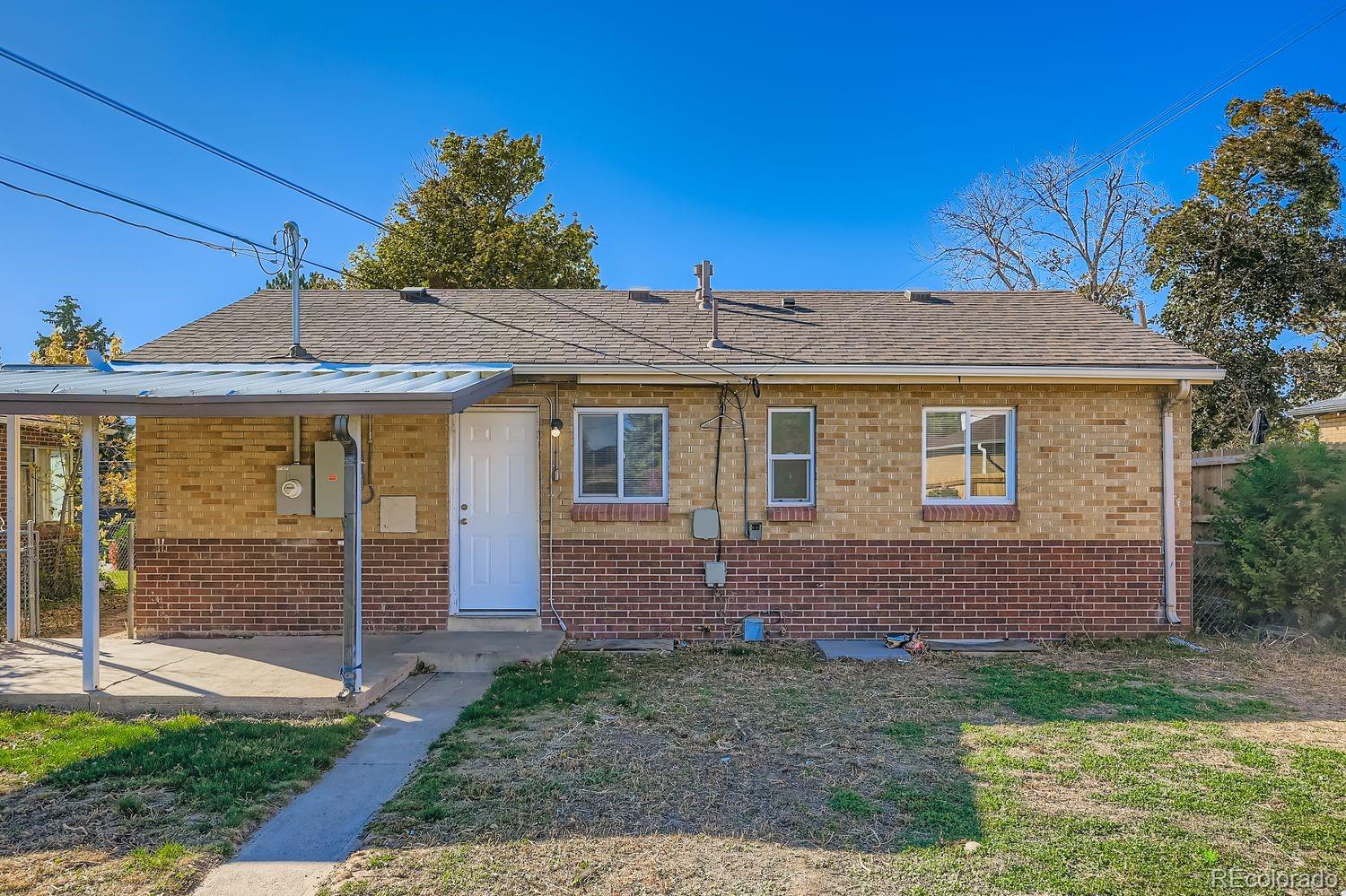 3690 Magnolia Street Denver, CO 80207 - Photo 15 of 17 a front view of a house with garden