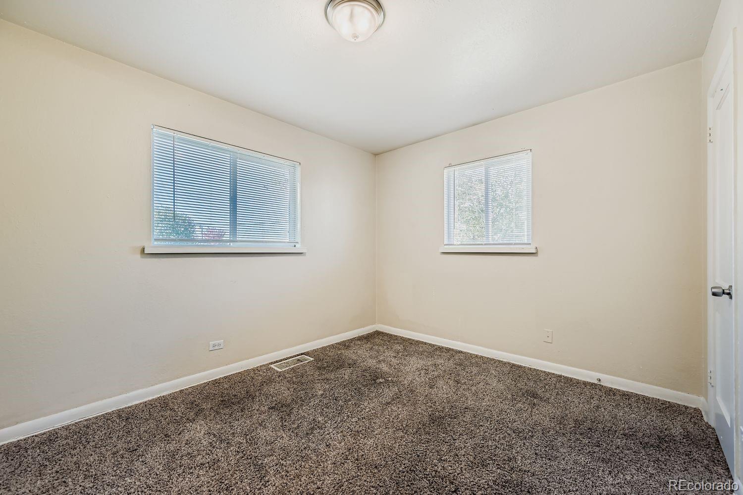 3690 Magnolia Street Denver, CO 80207 - Photo 6 of 17 a view of an empty room with a window
