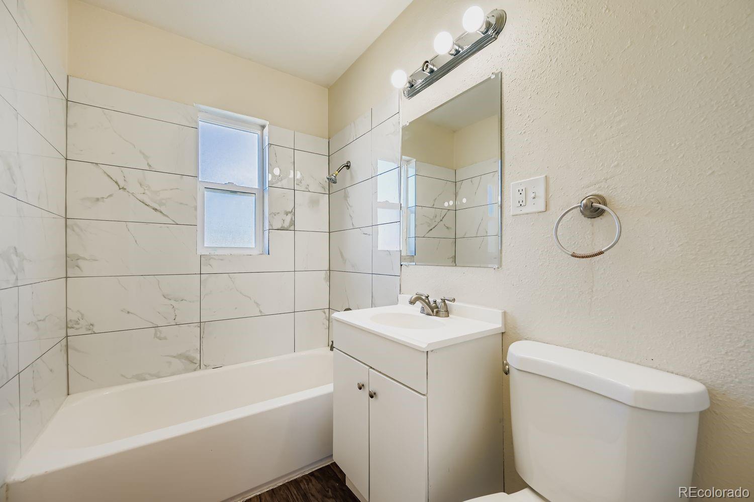 3690 Magnolia Street Denver, CO 80207 - Photo 8 of 17 a bathroom with a sink a toilet and bathtub