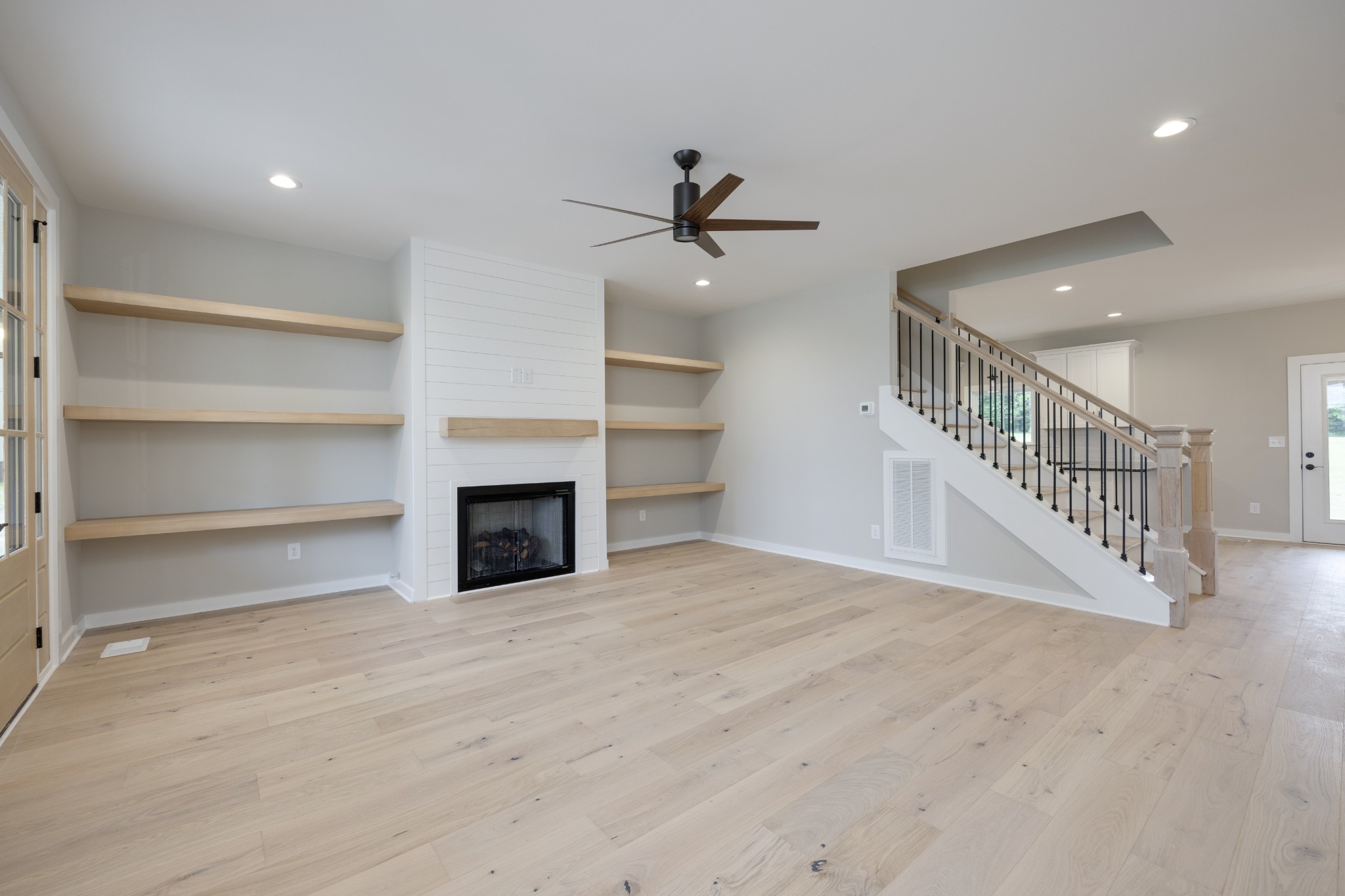 248 Dink Rut Road Portland, TN 37148 - Photo 11 of 41 a view of a livingroom with a fireplace a ceiling fan and windows