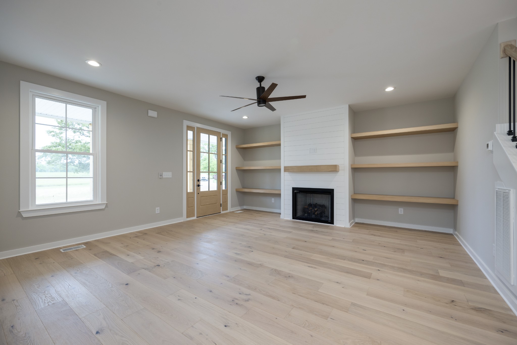 248 Dink Rut Road Portland, TN 37148 - Photo 12 of 41 a view of an empty room with a window and a fireplace