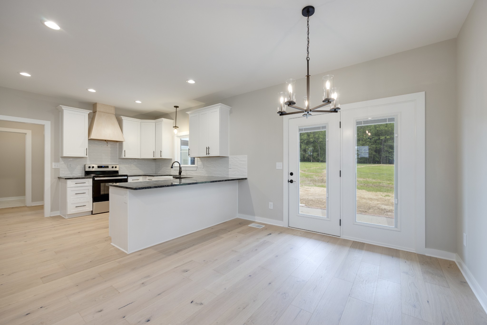 248 Dink Rut Road Portland, TN 37148 - Photo 15 of 41 a large kitchen with granite countertop a large counter top a sink stainless steel appliances and cabinets