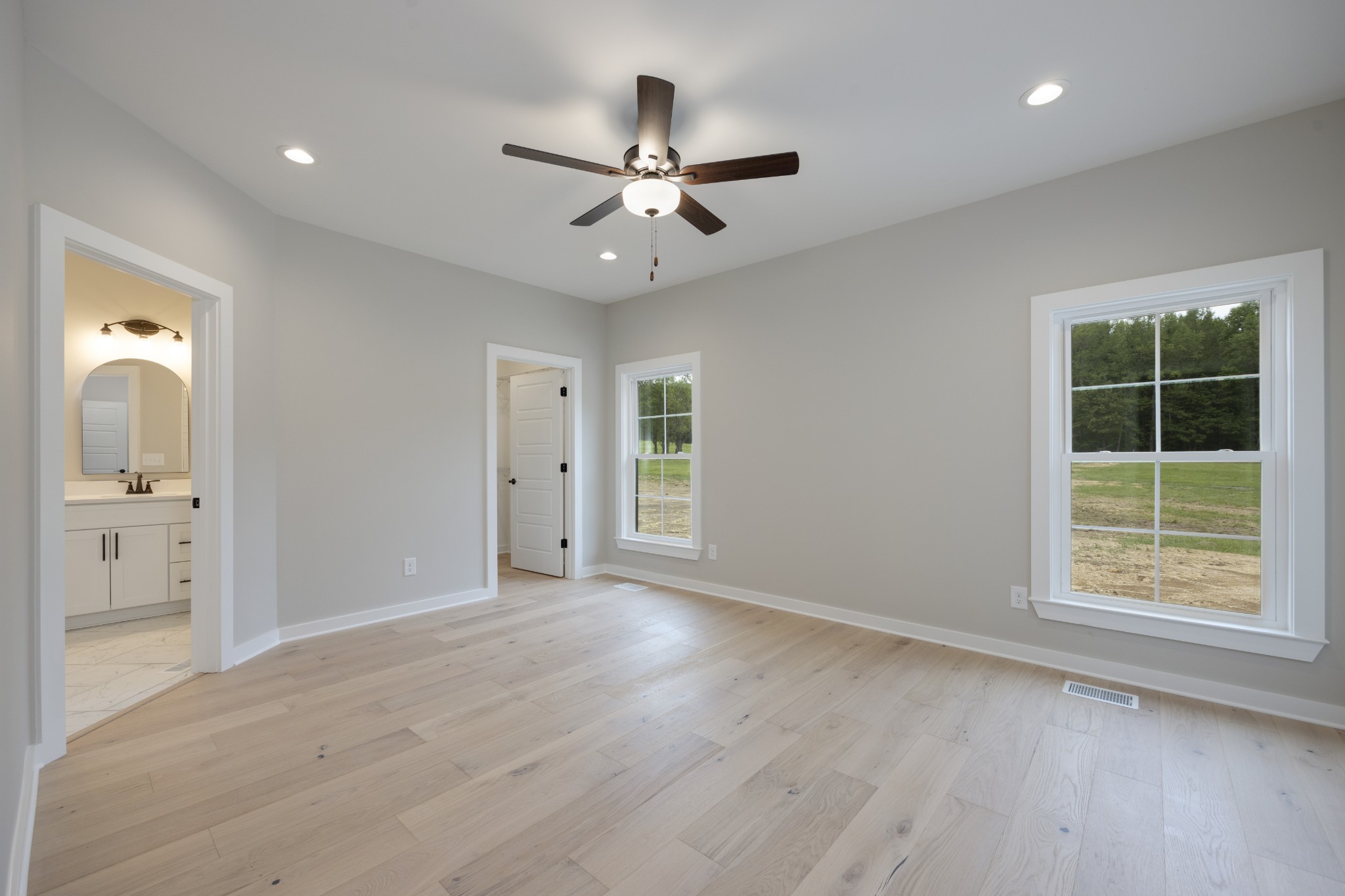 248 Dink Rut Road Portland, TN 37148 - Photo 22 of 41 an empty room with wooden floor a ceiling fan and windows