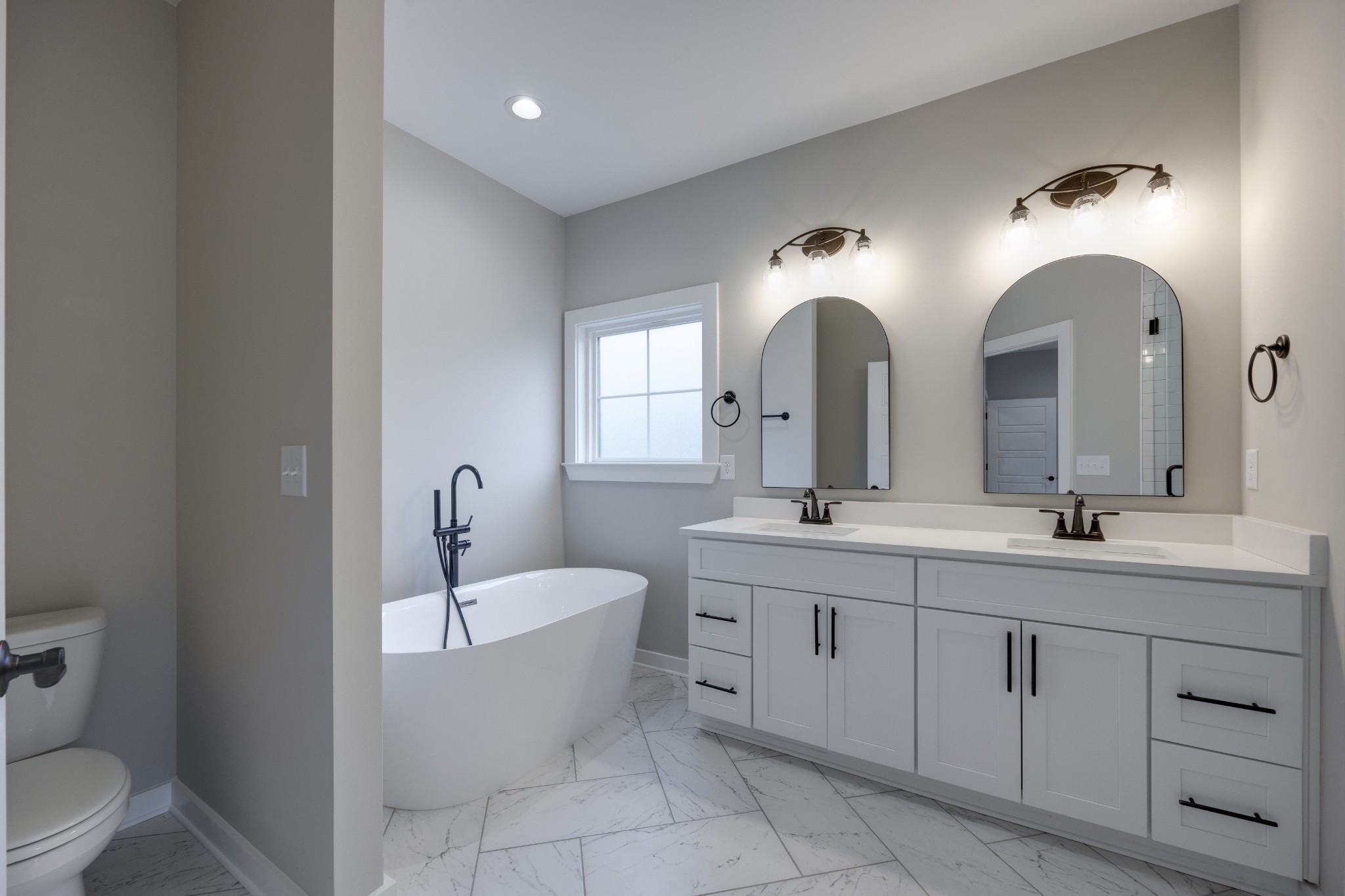 248 Dink Rut Road Portland, TN 37148 - Photo 24 of 41 a bathroom with a double vanity sink a mirror and a toilet