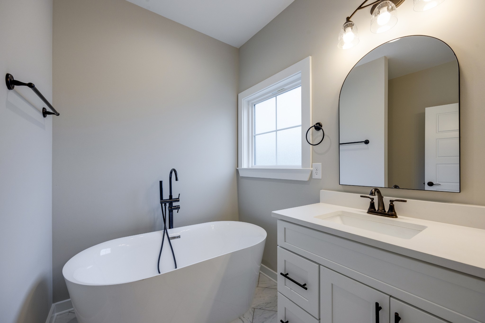 248 Dink Rut Road Portland, TN 37148 - Photo 26 of 41 a bathroom with a white tub a sink and mirror