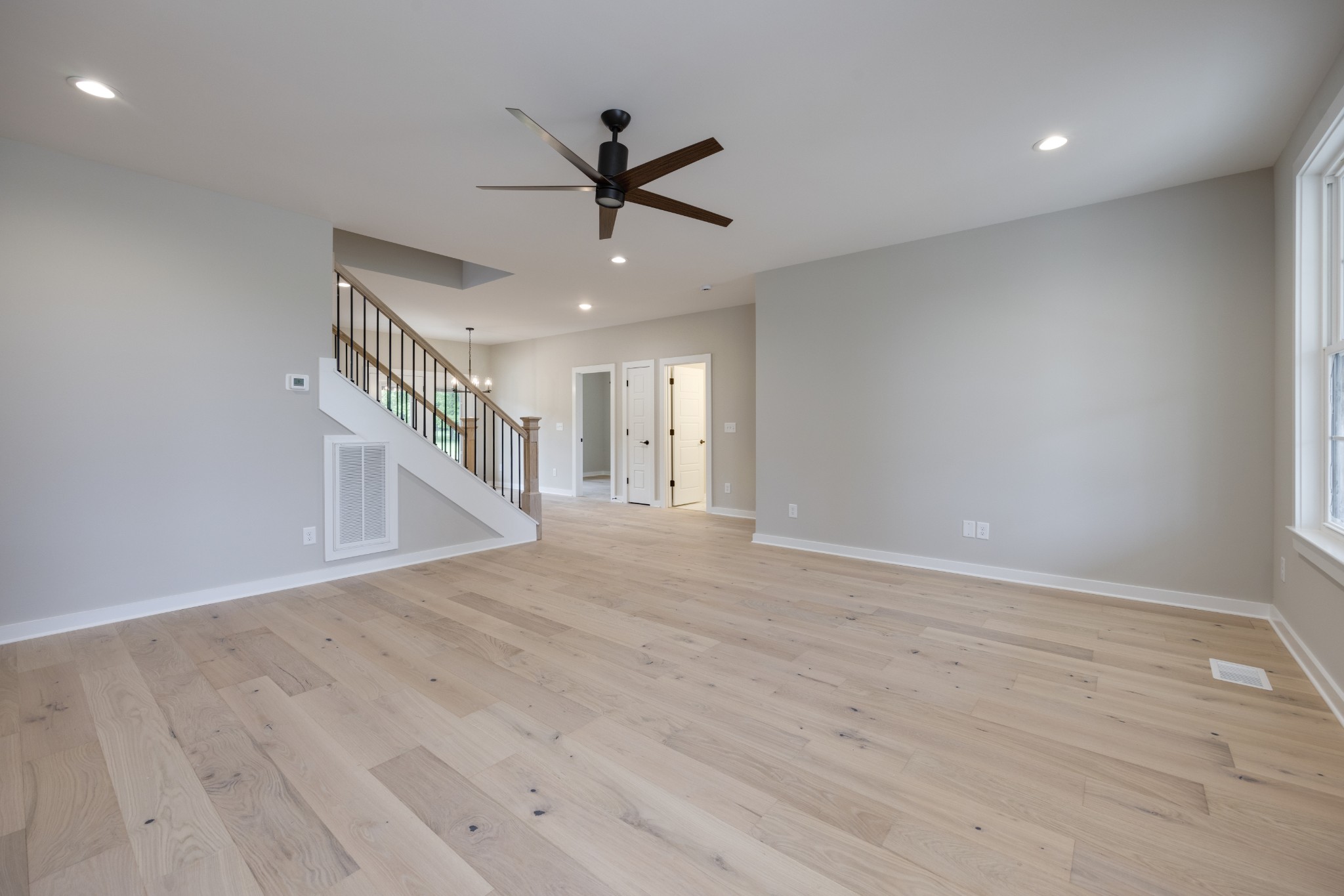 248 Dink Rut Road Portland, TN 37148 - Photo 10 of 41 a view of an empty room with wooden floor and a ceiling fan