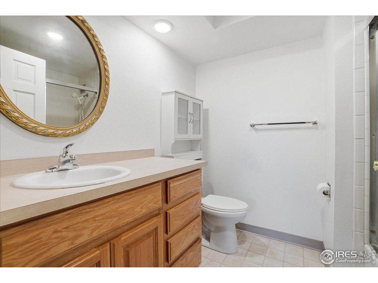 415 South Howes Street, Unit N206 Fort Collins, CO 80521 - Photo 21 of 48 a bathroom with a granite countertop sink a toilet and a mirror