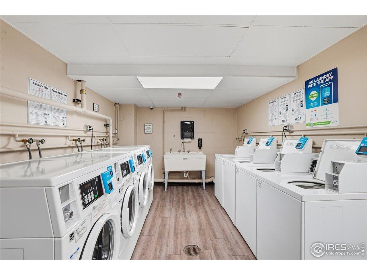 415 South Howes Street, Unit N206 Fort Collins, CO 80521 - Photo 26 of 48 a kitchen that has a lot of white cabinets and wooden floor