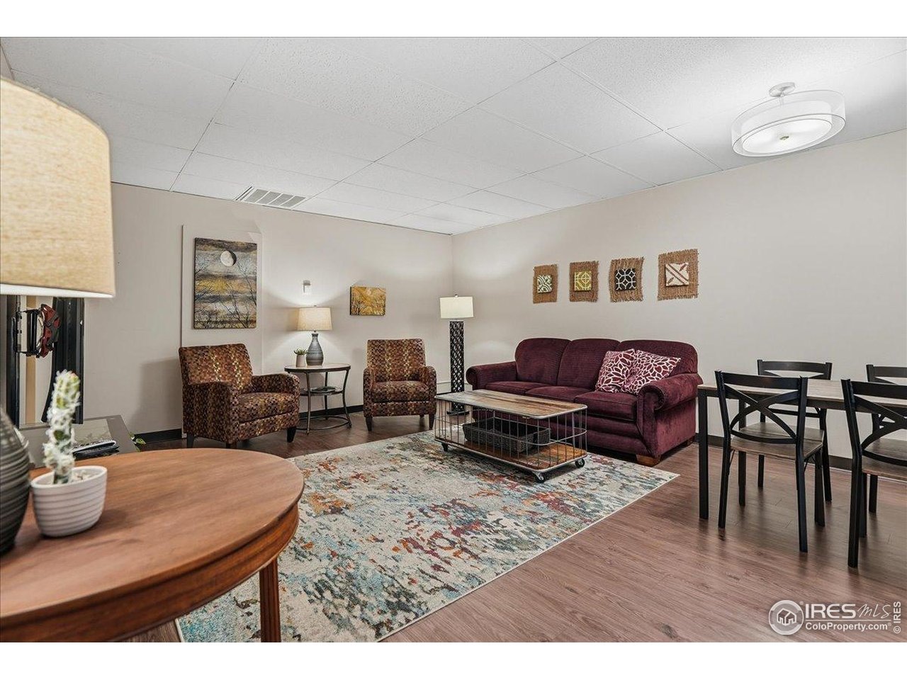 415 South Howes Street, Unit N206 Fort Collins, CO 80521 - Photo 34 of 48 a living room with furniture a wooden floor and a flat screen tv