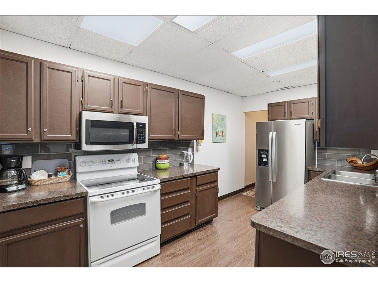 415 South Howes Street, Unit N206 Fort Collins, CO 80521 - Photo 36 of 48 a kitchen with stainless steel appliances granite countertop a refrigerator stove top oven a sink and dishwasher