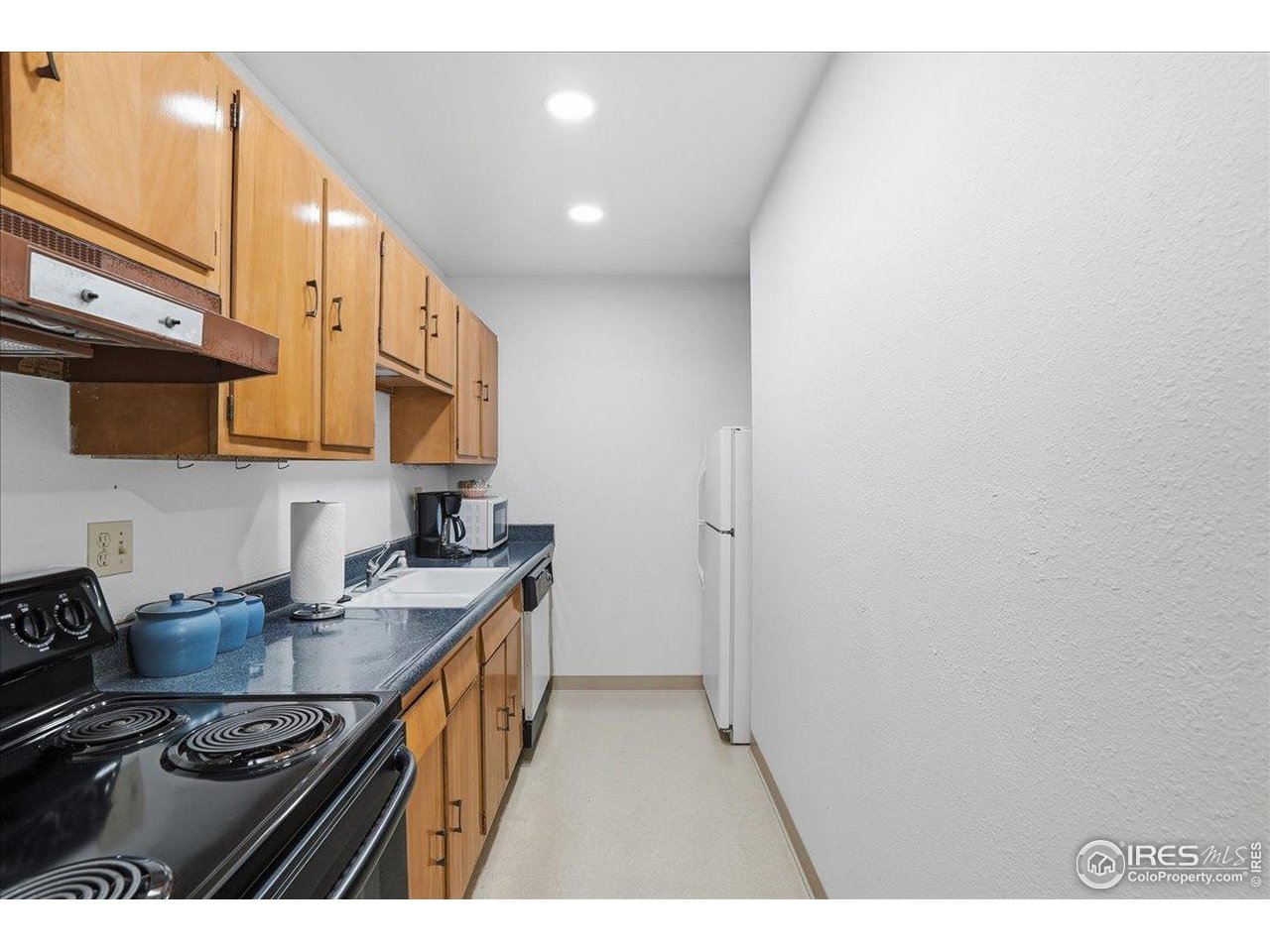 415 South Howes Street, Unit N206 Fort Collins, CO 80521 - Photo 41 of 48 a kitchen with stainless steel appliances granite countertop a stove a sink and a microwave