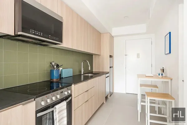a kitchen with granite countertop a stove and a microwave
