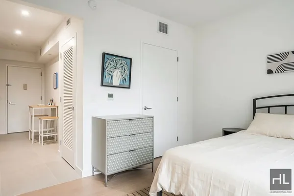 a bedroom with a bed and a desk