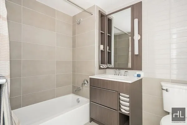 a bathroom with a sink a mirror and a bathtub