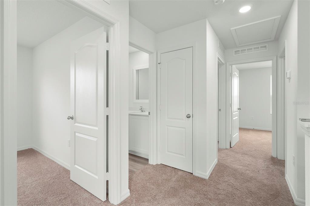 13291 Tula Loop Astatula, FL 34705 - Photo 11 of 22 a view of a hallway with closet and bathroom