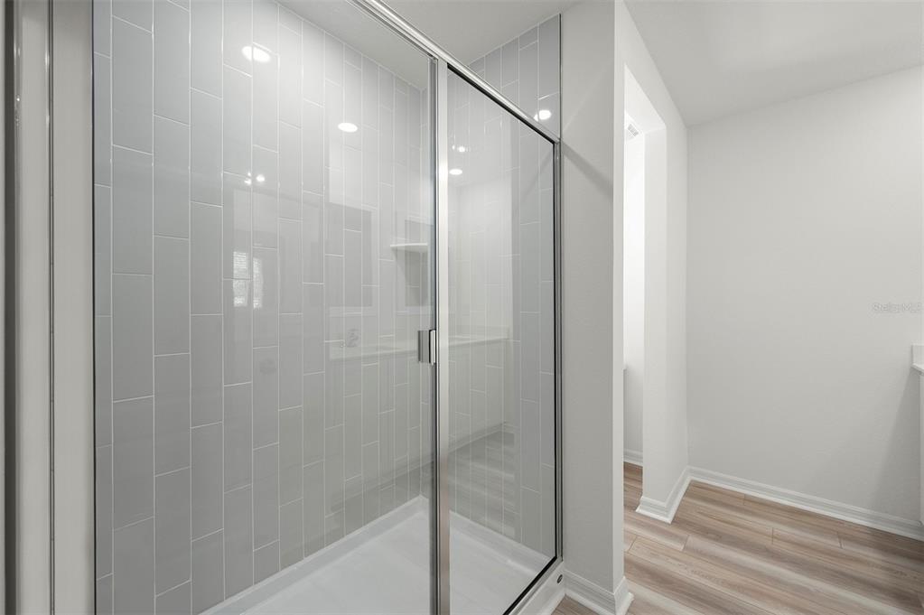 13291 Tula Loop Astatula, FL 34705 - Photo 15 of 22 a bathroom with a shower and a glass door