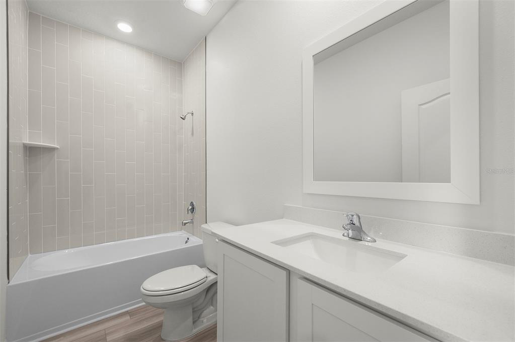 13291 Tula Loop Astatula, FL 34705 - Photo 19 of 22 a bathroom with a sink a toilet and shower