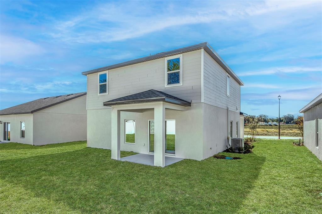 13291 Tula Loop Astatula, FL 34705 - Photo 20 of 22 a view of a house with backyard