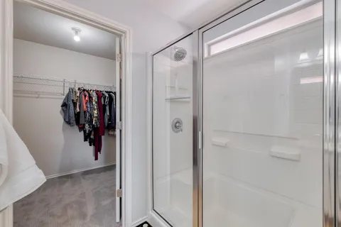 a view of walk in closet with clothes