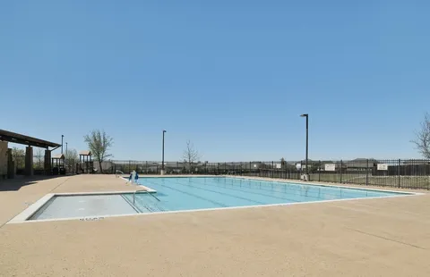 a view of a swimming pool and a yard