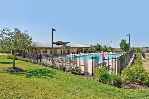 a front view of house with a garden