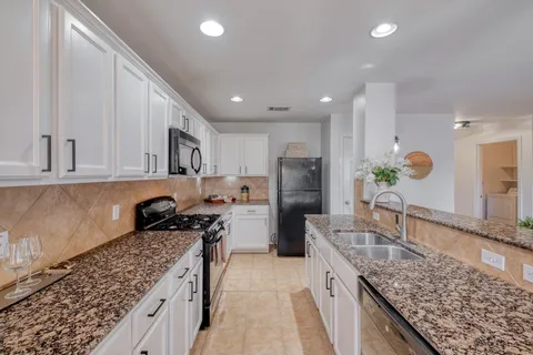 a kitchen with refrigerator and cabinets