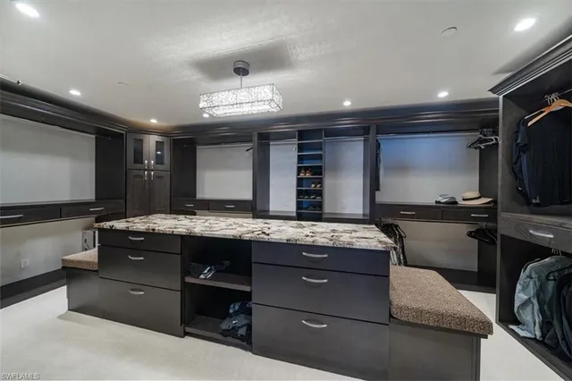 a large kitchen with a counter space a sink stainless steel appliances and cabinets