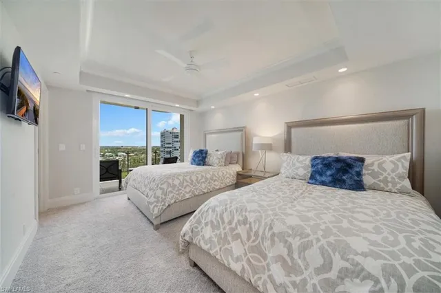 a bedroom with two beds and a large mirror