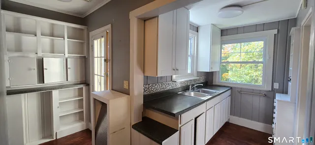 a kitchen with a sink cabinets and a window