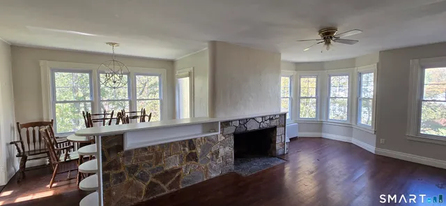 a view of a livingroom with furniture window and wooden floor