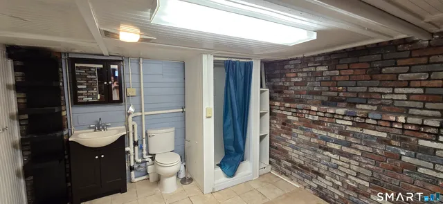 a bathroom with a toilet and a shower