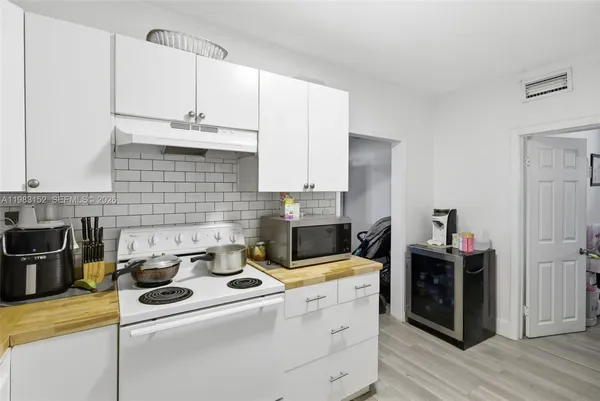 a kitchen with a stove and cabinets