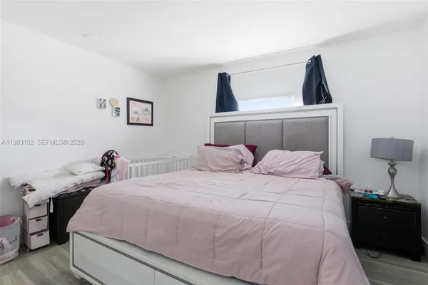 a bedroom with a bed and a lamp