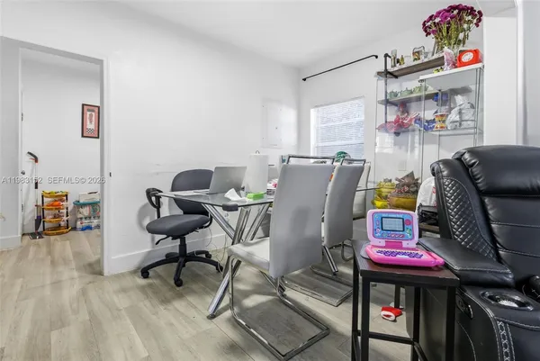 a workspace with furniture and a ceiling fan