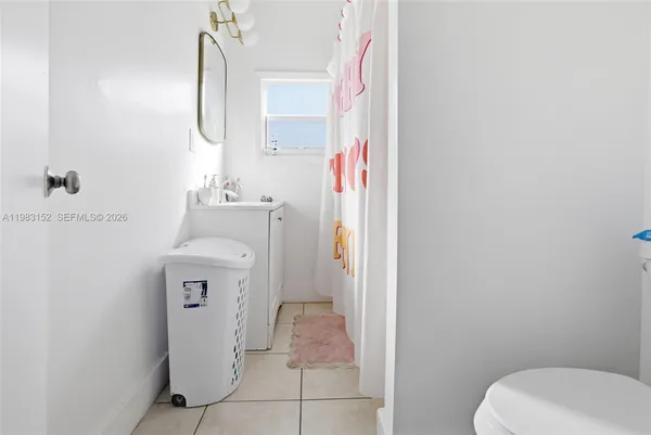 a bathroom with a sink toilet and mirror