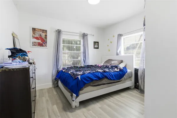 a bed sitting in a bedroom next to a window