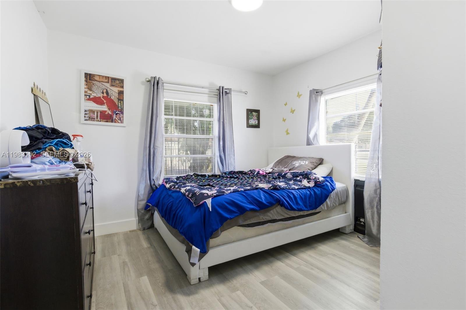 2142 Northwest 33rd Street Miami, FL 33142 - Photo 20 of 26 a bed sitting in a bedroom next to a window