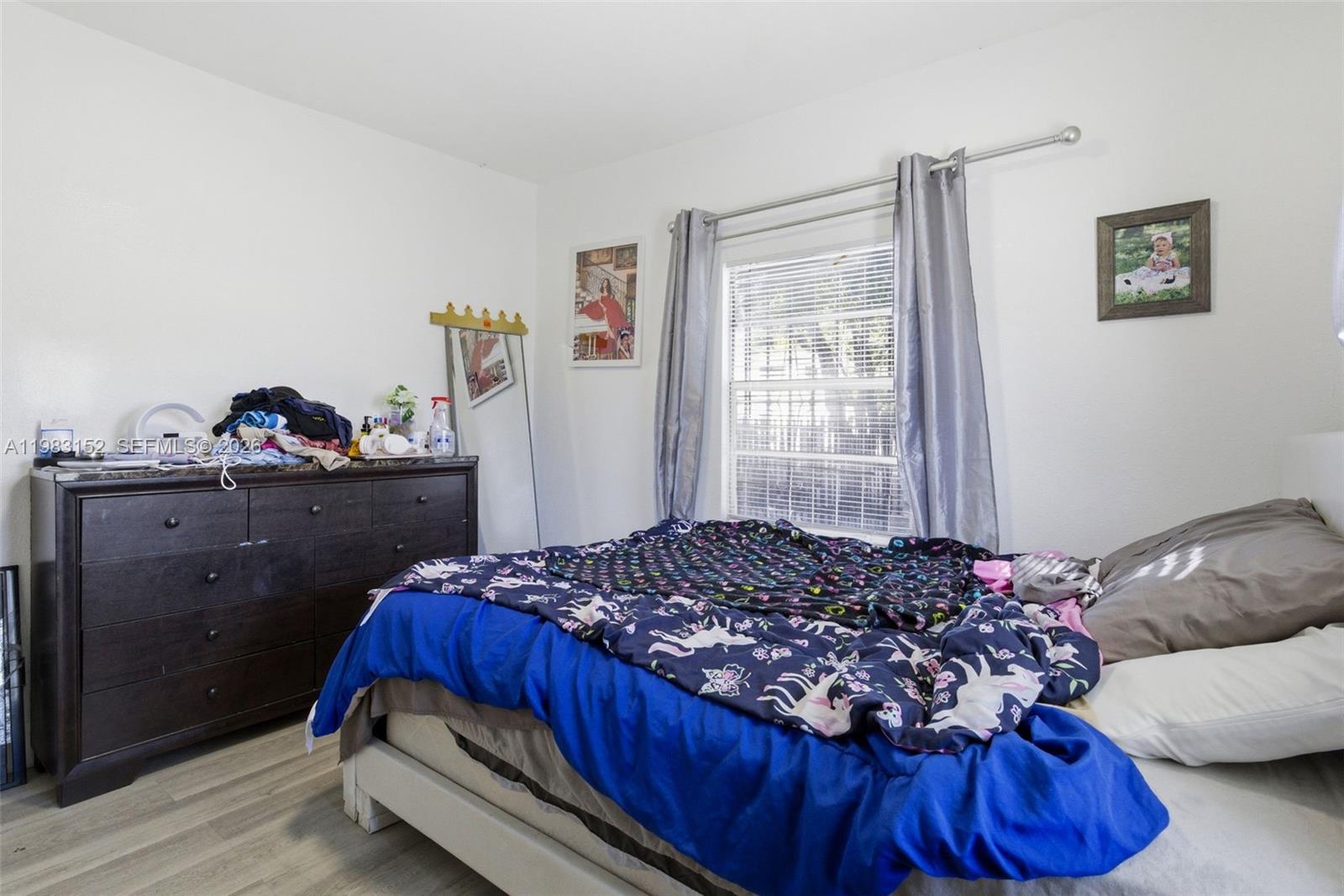 2142 Northwest 33rd Street Miami, FL 33142 - Photo 25 of 26 a bed sitting in a bedroom next to a window
