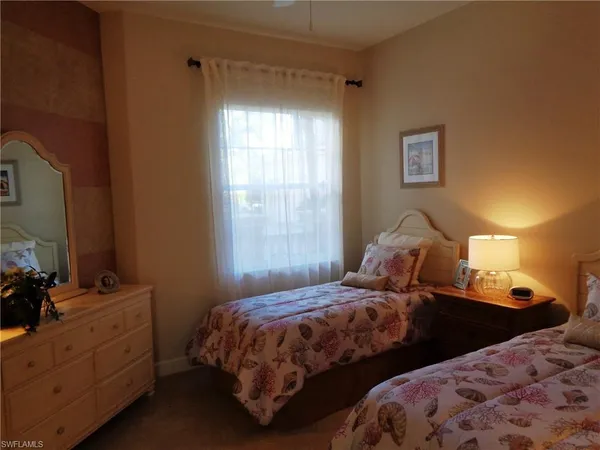 a bedroom with a bed and lamp