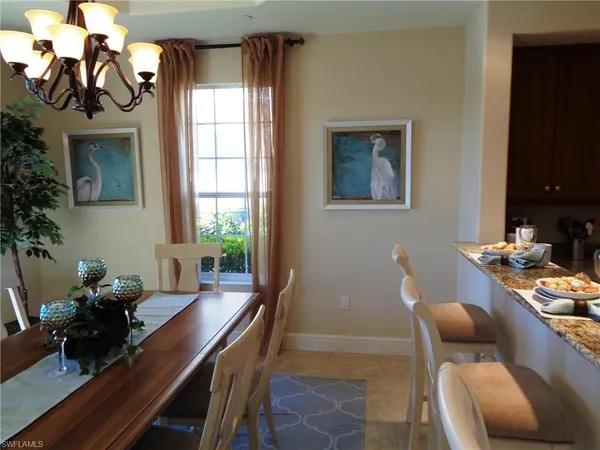 a dining room with furniture and a potted plant