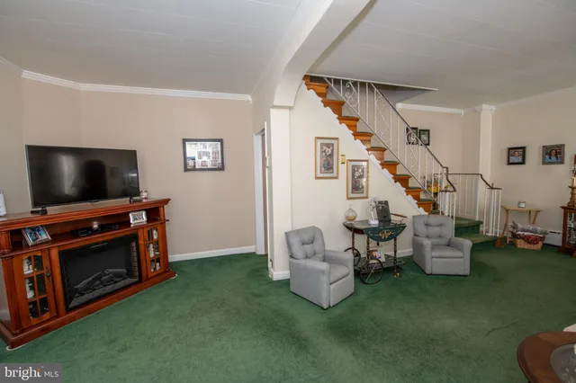 a living room with furniture and stairs