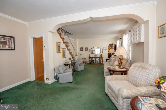 a kitchen with stainless steel appliances granite countertop a dining table chairs and a refrigerator