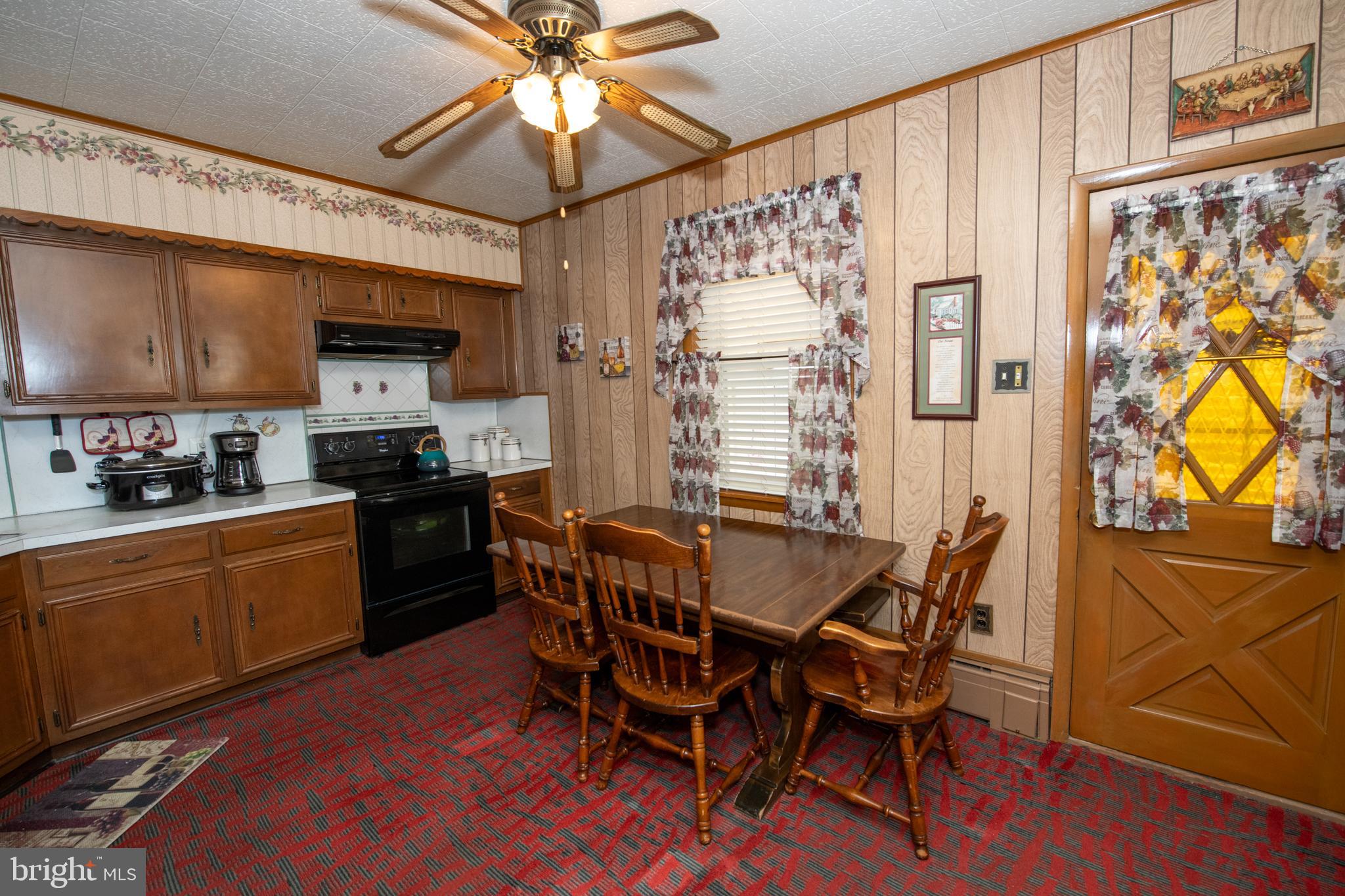 2740 Pratt Street Philadelphia, PA 19137 - Photo 15 of 45 a kitchen with stainless steel appliances granite countertop a dining table chairs and a refrigerator