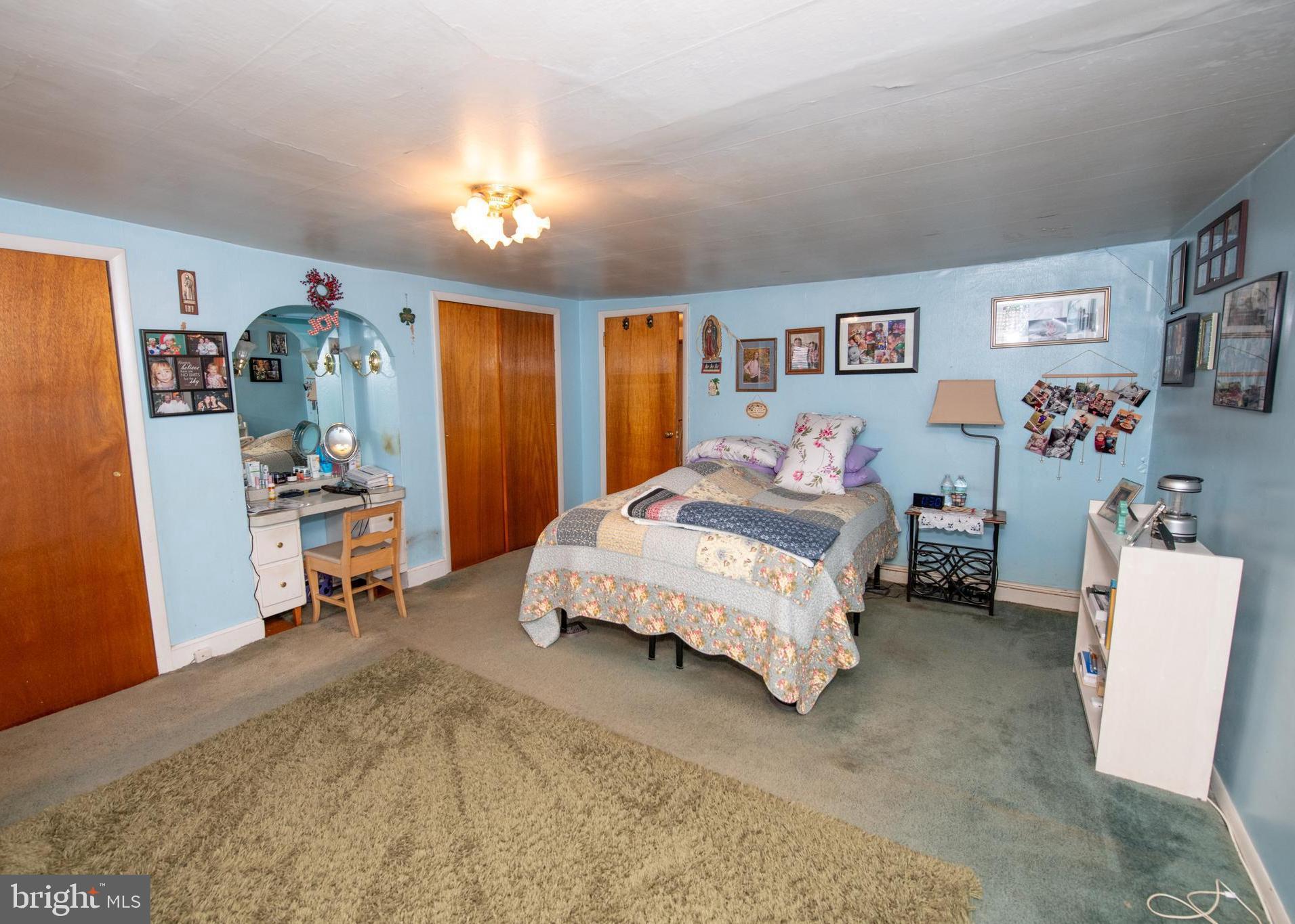 2740 Pratt Street Philadelphia, PA 19137 - Photo 20 of 45 a spacious bedroom with a bed and a chandelier