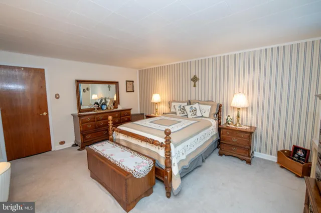 a spacious bedroom with a bed and window