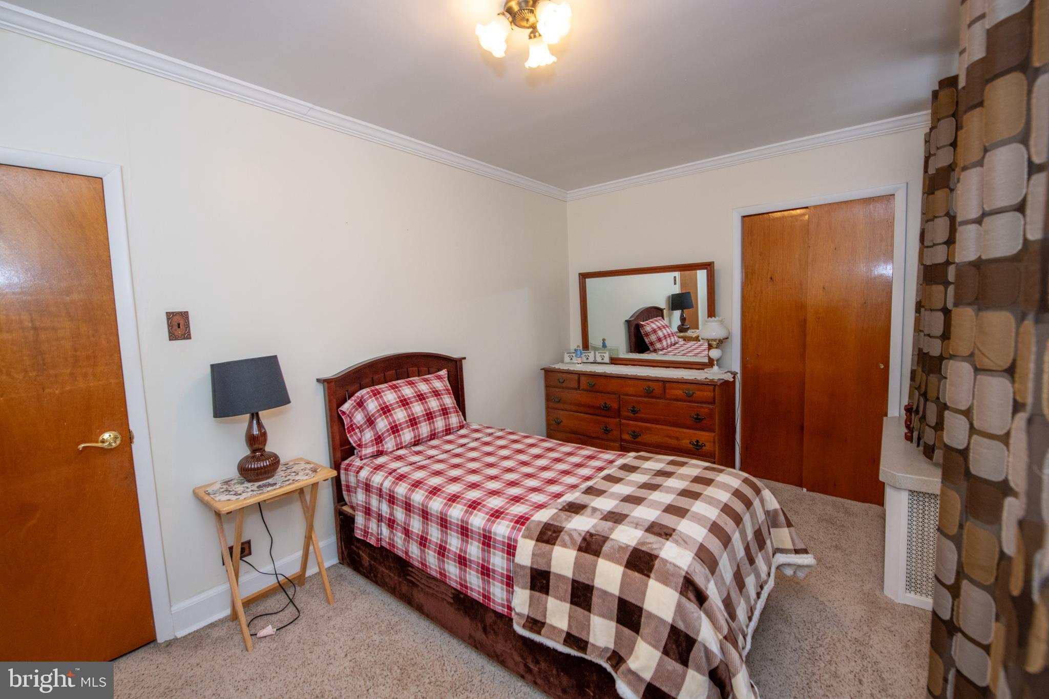 2740 Pratt Street Philadelphia, PA 19137 - Photo 30 of 45 a bedroom with a bed and lamp